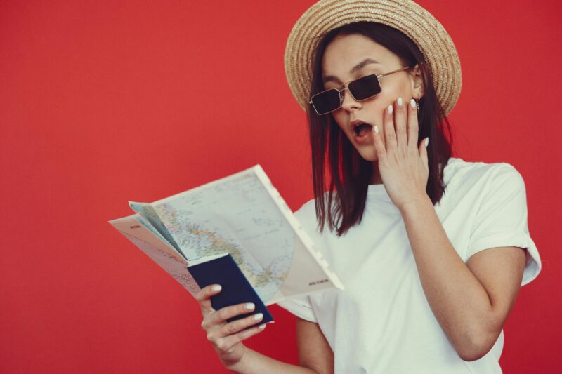 girl looking at map and holding passport